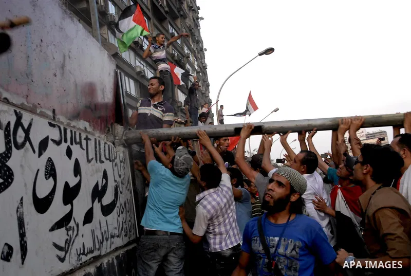 Egyptian protesters dismantle the concrete wall which was built in front of the Israeli embassy, in Cairo, Egypt, 09 September 2011. Security forces had built the wall in an attempt to secure the embassy after a series o...