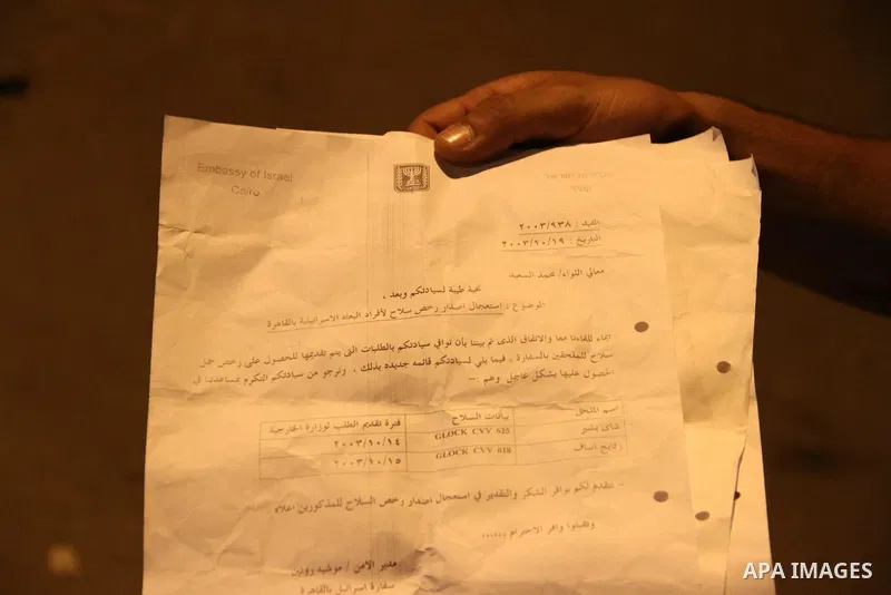An Egyptian protester holds documents he snatched from the Israeli embassy in Cairo, Egypt, early Saturday, Sept. 10, 2011. Protesters broke into the embassy Friday and dumped documents out of the windows as hundreds mor...