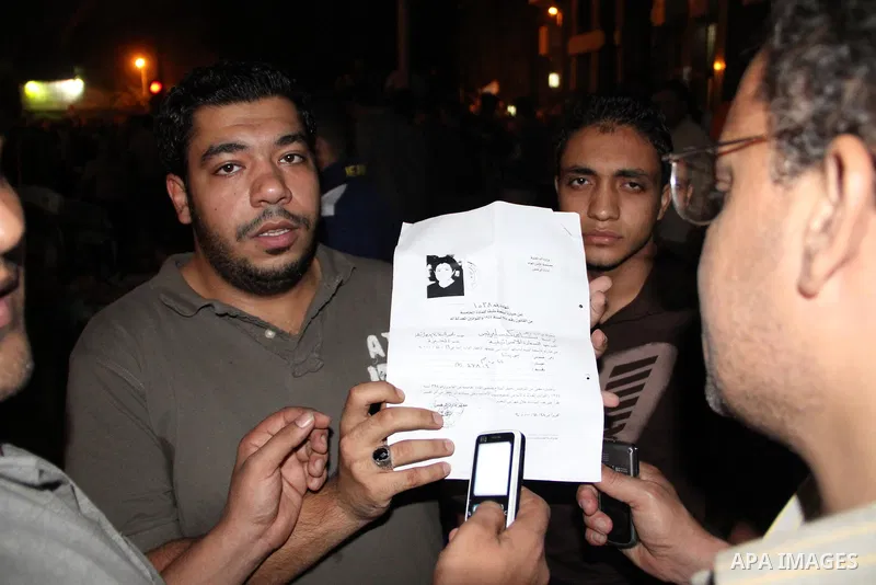 An Egyptian protester holds documents he snatched from the Israeli embassy in Cairo, Egypt, early Saturday, Sept. 10, 2011. Protesters broke into the embassy Friday and dumped documents out of the windows as hundreds mor...