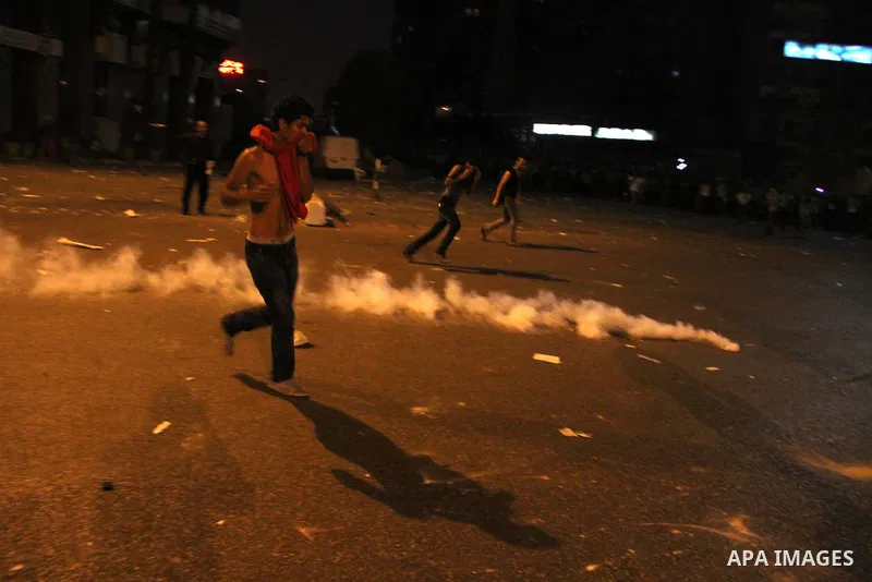 Egyptian demonstrators throw stones at police early on September 10, 2011 during clashes outside the Israeli embassy in Cairo after protesters raided the building. Photo by Ahmed Asad