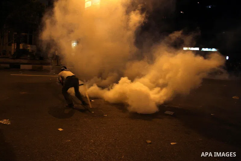 Egyptian demonstrators throw stones at police early on September 10, 2011 during clashes outside the Israeli embassy in Cairo after protesters raided the building. Photo by Ahmed Asad