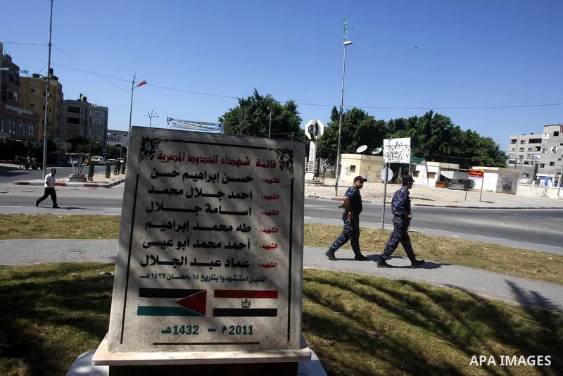 Palestinian policemen walk near the memorial site in memory of the Egyptian policemen who were killed by the Israeli army in Gaza city on Sep.10, 2011. While the Egyptians held a series of protests in front of the Israel...