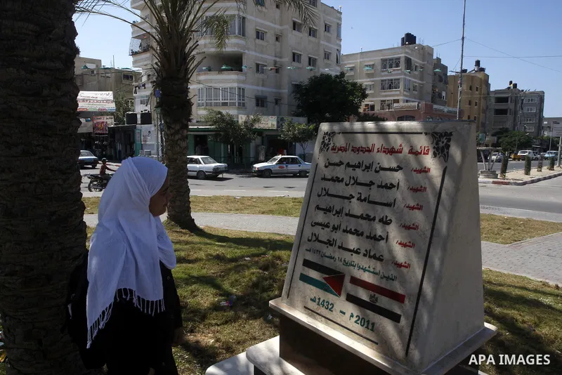 A Palestinian girl stands infront of the memorial site in memory of the Egyptian policemen who were killed by the Israeli army in Gaza city on Sep.10, 2011. While the Egyptians held a series of protests in front of the I...
