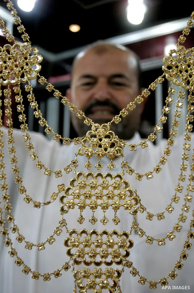 A Palestinian vendor displays a gold jewellery at a jewellery store in the Rafah Refugee Camp, Southern Gaza Strip on Sep. 10, 2011. Decline in demand for gold in the Palestinian markets due to the high price of $ 50 per...