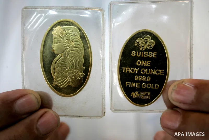 A Palestinian vendor displays a gold jewellery at a jewellery store in the Rafah Refugee Camp, Southern Gaza Strip on Sep. 10, 2011. Decline in demand for gold in the Palestinian markets due to the high price of $ 50 per...