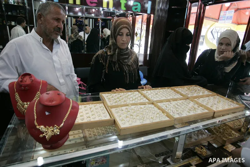 Palestinian women look at gold jewellery at a jewellery store in the Rafah Refugee Camp, Southern Gaza Strip on Sep. 10, 2011. Decline in demand for gold in the Palestinian markets due to the high price of $ 50 per gram,...