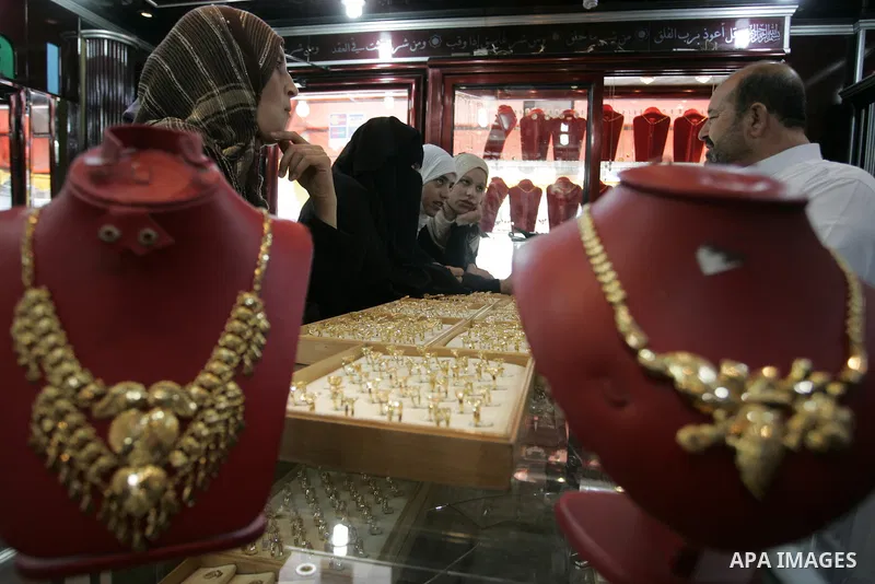 Palestinian women look at gold jewellery at a jewellery store in the Rafah Refugee Camp, Southern Gaza Strip on Sep. 10, 2011. Decline in demand for gold in the Palestinian markets due to the high price of $ 50 per gram,...