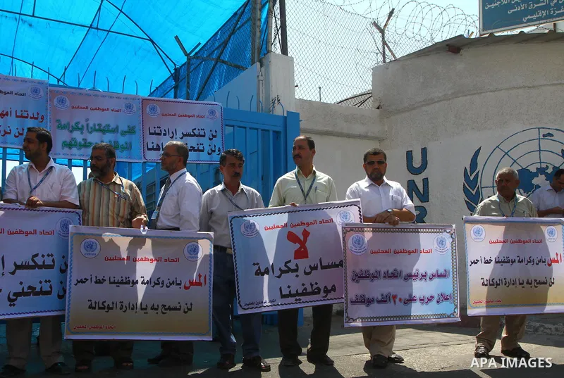 Palestinians take part in a protest against the decision to stop the head of the Federation of staff, Suhail al-Hindi to work temporarily, infront of the UNRWA headquarters in Gaza city on Sep. 11, 2011. Union officials...