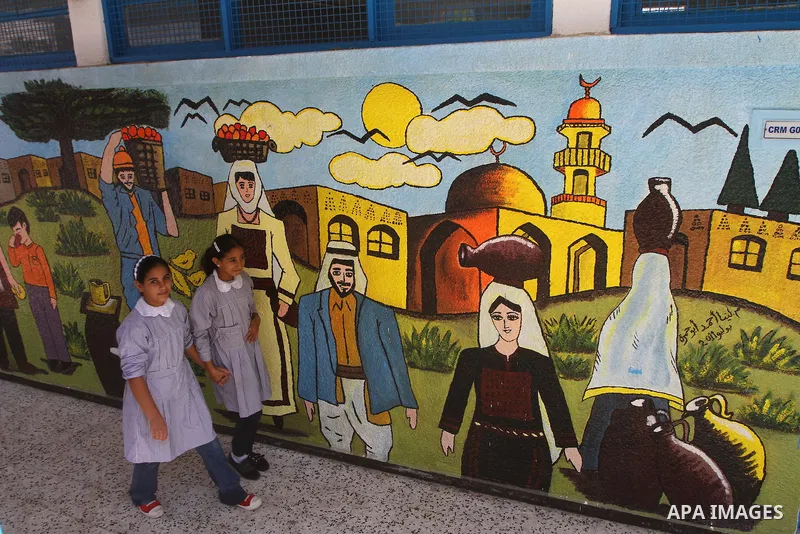 Palestinian students walk in the schools of Relief and Works Agency refugees "UNRWA", studying at the "containers" made of tin because of overcrowding and the inability to accommodate large numbers of students in Gaza ci...