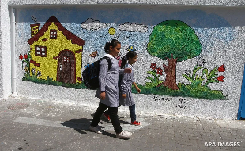 Palestinian students walk in the schools of Relief and Works Agency refugees "UNRWA", studying at the "containers" made of tin because of overcrowding and the inability to accommodate large numbers of students in Gaza ci...