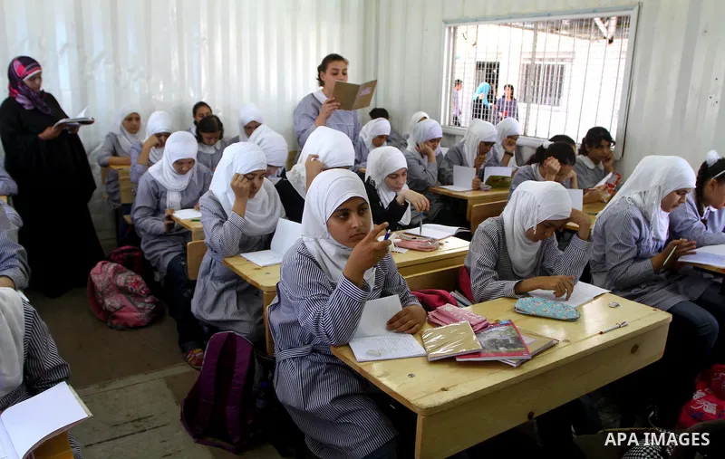 Palestinian students crammed in the schools of Relief and Works Agency refugees "UNRWA" studying at the "containers" made of tin because of overcrowding and the inability to accommodate large numbers of students in Gaza...