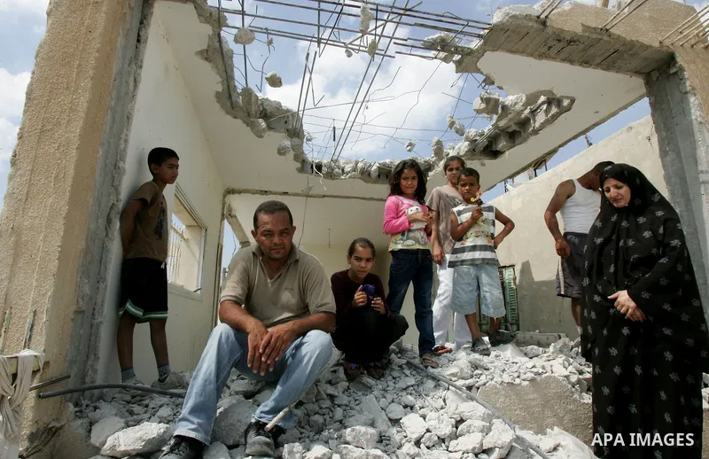 Palestinian Jerusalem resident Adnan Taha destroys his own home with a fellow Palestinian in Arab east Jerusalem on September 11, 2011, in implementation of an Israeli court order which ruled that the house was built wit...
