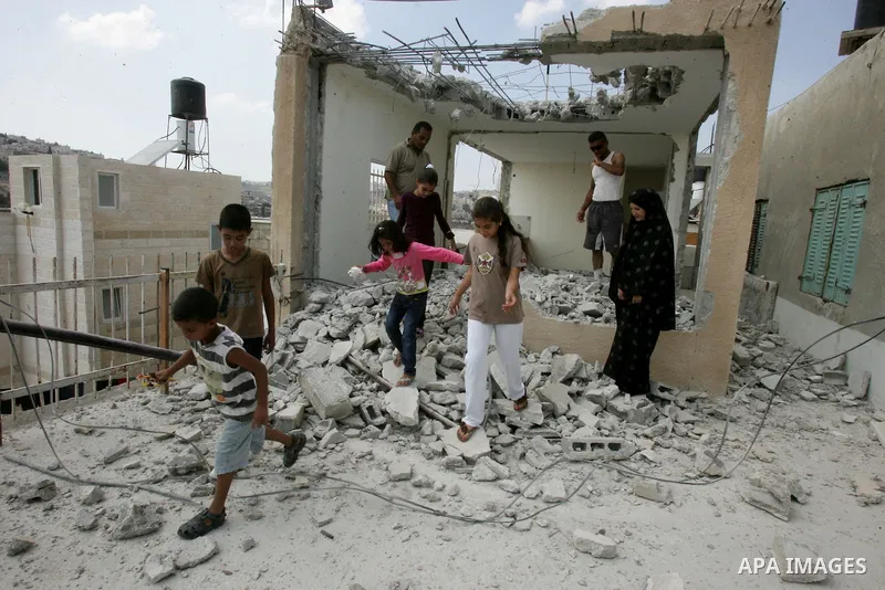 Palestinian Jerusalem resident Adnan Taha destroys his own home with a fellow Palestinian in Arab east Jerusalem on September 11, 2011, in implementation of an Israeli court order which ruled that the house was built wit...