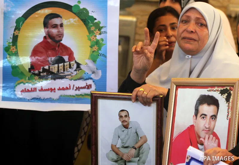 Palestinian women hold pictures of their prisoned relatives in Israeli jails as they gather in a weekly activity calling for their liberty at the Red Cross headquarters in Gaza City on Sep. 12, 2011. About 7000 prisoners...