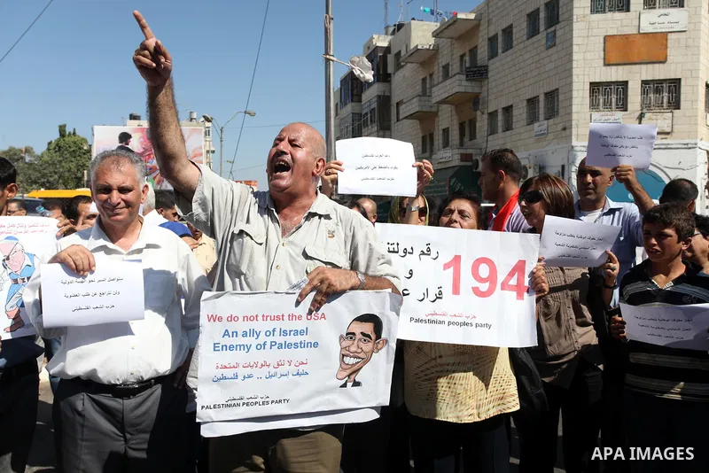 Palestinians hold signs depicting Israel's Prime Minister Benjamin Netanyahu as a pirate during a demonstration supporting the Palestinians' bid for statehood, in the West Bank city of Ramallah, on Sep.12, 2011. The Pale...