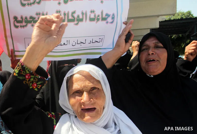 Palestinians shout slogans during a rally supporting a bid for Palestinian statehood recognition at the U.N., at a United Nations Relief and Works Agency (UNRWA) food distribution center in Rafah in the southern Gaza Str...