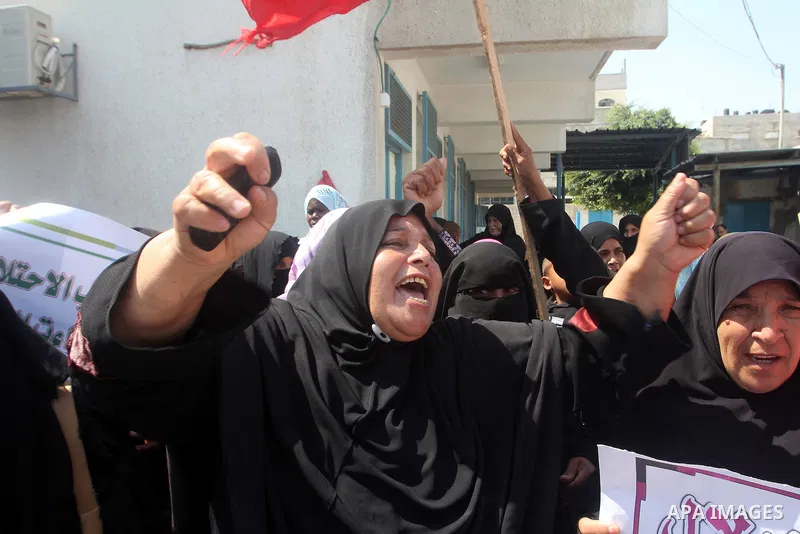 Palestinians shout slogans during a rally supporting a bid for Palestinian statehood recognition at the U.N., at a United Nations Relief and Works Agency (UNRWA) food distribution center in Rafah in the southern Gaza Str...