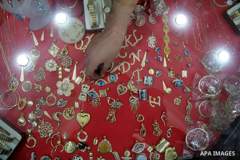 A Palestinian goldsmith displays Chinese jewellery at a jewellery shop in the southern Gaza Strip town of Rafah on September 12, 2011. The price of the Chinese gold is 15 dollars instead of 50 dollars for the other origi...