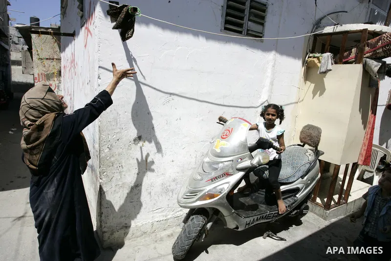 A Palestinian girl sits on Motorcycle in the street in the Rafah Refugee Camp, Southern Gaza Strip on September 13, 2011. A diplomatic showdown looms at the United Nations this month when Palestinian President Mahmoud Ab...
