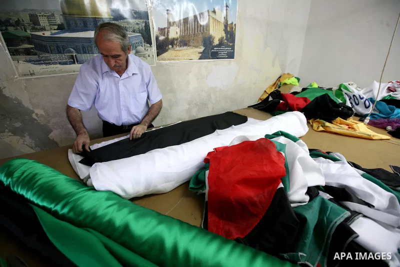 A Palestinian Nabil al-Saed makes Palestinian flags in a factory in the West Bank city of Hebron on 13 September 2011. According to Nabil al-Saed, with the Palestinian push for recognition of statehood at the United Nati...