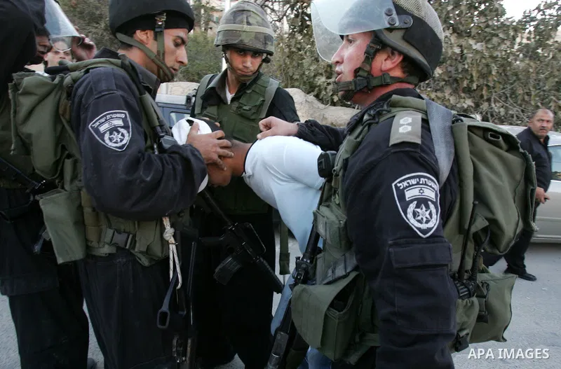 Israeli riot policemen detain a Palestinian youth in the east Jerusalem neighborhood of Silwan on Sep. 13, 2011 following brief clashes between police and Palestinian stone throwers. Photo by Mahfouz Abu Turk