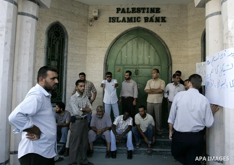 Employees of the Palestinian Authority reject to receive their salaries from the Islamic Bank in Rafah, southern Gaza Strip on Sep. 14, 2011. They explained that this procedure is deducted from the salary of each employe...