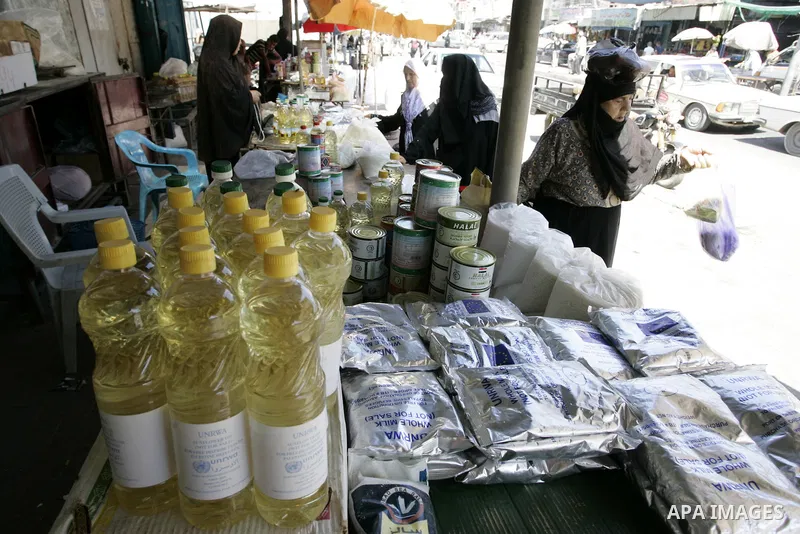 Palestinians receive their food aid from a UN distribution centre in the Rafah refugee camp, southern Gaza Strip on Sep. 14, 2011. Germany provided for the first time a donation to the school's nutrition program, and the...