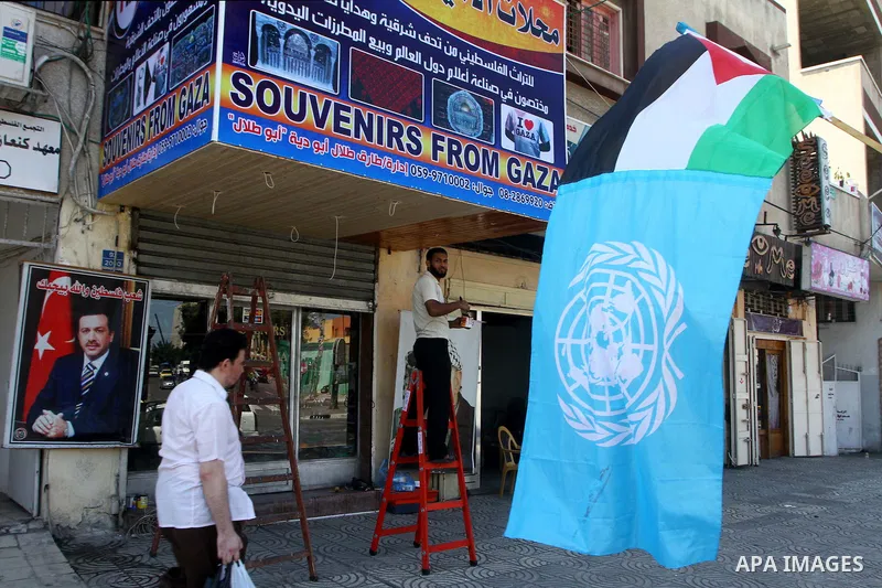 A Palestinian and UN flag flutter outside a souvenirs shop in Gaza City as part of the campaign promoting the Palestinians' bid for statehood on September 14, 2011. The Palestinians are preparing to submit a formal reque...