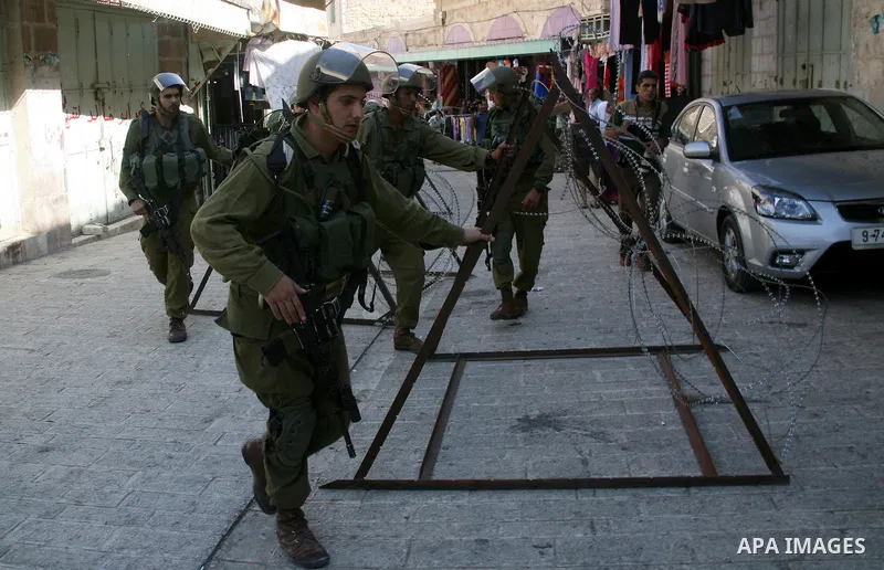 Israeli soldiers close the road during a rally against the closure of Shuhada Street in Hebron, the main artery blocked by an Israeli military checkpoint in the center of the West Bank town of Hebron Sep. 14, 2011. Pales...