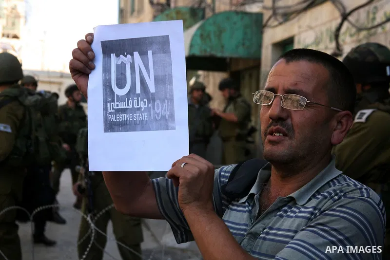Palestinians take part in a rally against the closure of Shuhada Street in Hebron, the main artery blocked by an Israeli military checkpoint in the center of the West Bank town of Hebron Sep. 14, 2011. Palestinians demon...