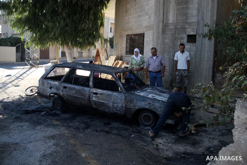 Palestinians inspect a burnt car in the village of Beit Furik, near the West Bank town of Nablus, on Sept. 15, 2011. Vandals set fire to three cars in a West Bank village, and suspicion has fallen on Jewish settlers. Pal...