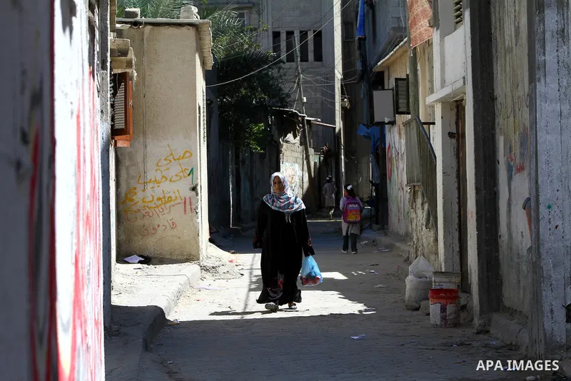 A Palestinian woman walks in al-Shate` refugee camp in Gaza City, on Sep. 15, 2011. President Mahmoud Abbas's bid to seek U.N. recognition of a Palestinian state is not generating much enthusiasm in the isolated Gaza Str...