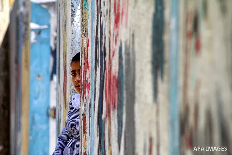 A Palestinian girl stands outside her house in al-Shate` refugee camp in Gaza City, on Sep. 15, 2011. President Mahmoud Abbas's bid to seek U.N. recognition of a Palestinian state is not generating much enthusiasm in the...
