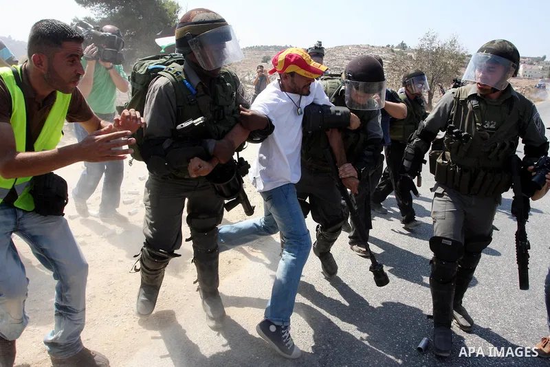 Israeli soldiers detain a Palestinian demonstrator during a protest against the expansion of the nearby Jewish settlement of Halamish, in the West Bank village of Nabi Saleh, near Ramallah, Friday, Sept. 16, 2011. Photo...
