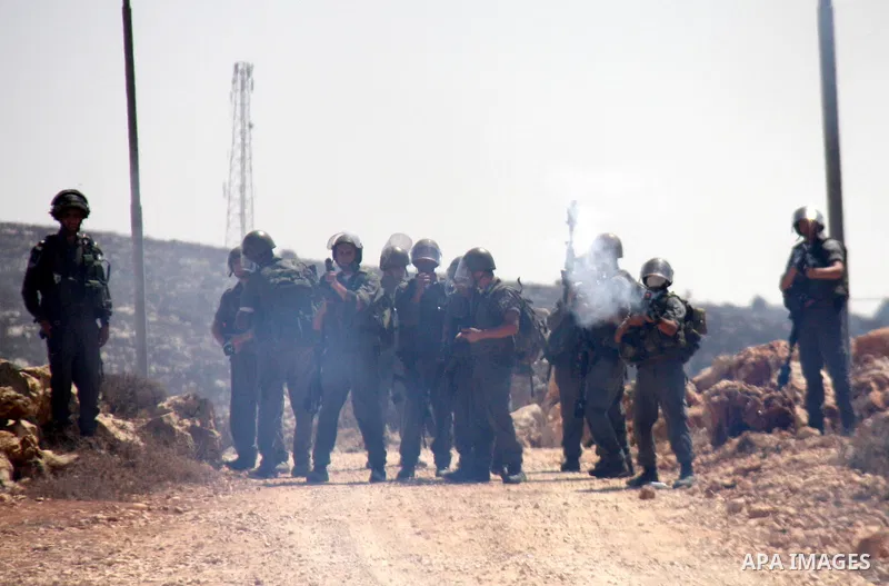 Israeli troops fire tear gas and rubber bullets during clashes with Palestinians at Qusra village near the West Bank city of Nablus on 16 September 2011. Israeli settlers assaulted the village Friday morning, leading to...