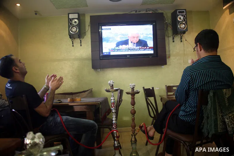 Customers in a Hebrow coffee shop watch TV as Palestinian Authority President Mahmud Abbas delivers a key speech ahead of the UN general assembly on September 16, 2011. Abbas said Palestinians are going to Security Counc...
