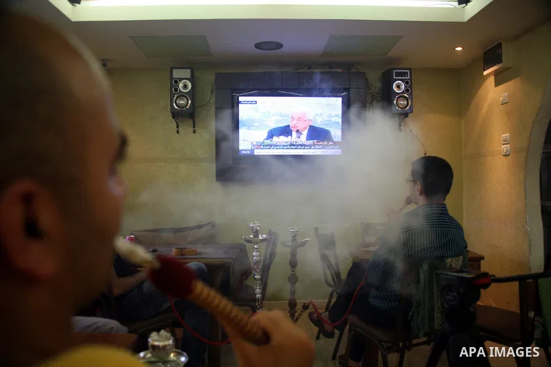 Customers in a Hebrow coffee shop watch TV as Palestinian Authority President Mahmud Abbas delivers a key speech ahead of the UN general assembly on September 16, 2011. Abbas said Palestinians are going to Security Counc...