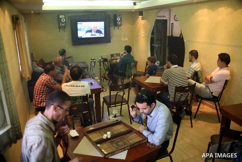 Customers in a Hebrow coffee shop watch TV as Palestinian Authority President Mahmud Abbas delivers a key speech ahead of the UN general assembly on September 16, 2011. Abbas said Palestinians are going to Security Counc...