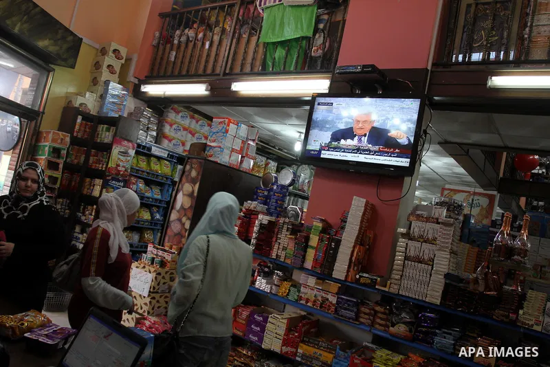 Customers in a Gaza mall watch TV as Palestinian Authority President Mahmud Abbas delivers a key speech ahead of the UN general assembly on September 16, 2011. Abbas said Palestinians are going to Security Council with U...