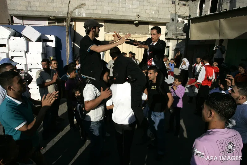 Palestinian friends and relatives celebrated the groom, Mohamed Gouda 24 years old, in the Rafah refugee camp, southern Gaza Strip on the eve of his wedding on Sep. 16, 2011, during the traditional celebration, Gouda was...