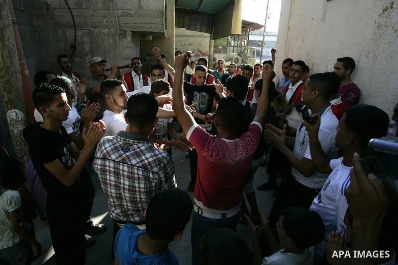 Palestinian friends and relatives celebrated the groom, Mohamed Gouda 24 years old, in the Rafah refugee camp, southern Gaza Strip on the eve of his wedding on Sep. 16, 2011, during the traditional celebration, Gouda was...