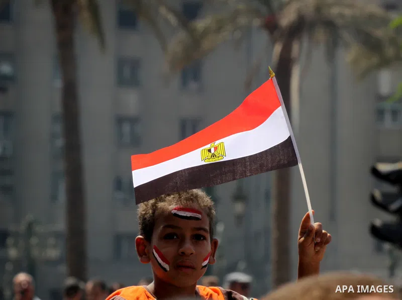 An Egyptian boy waves the Egyptian flag at Tahrir Square while hundreds of Egyptians demonstrate against the expansion of the Emergency Law at Al Tahrir Square. The law allows censorship, government imprisonment and more...