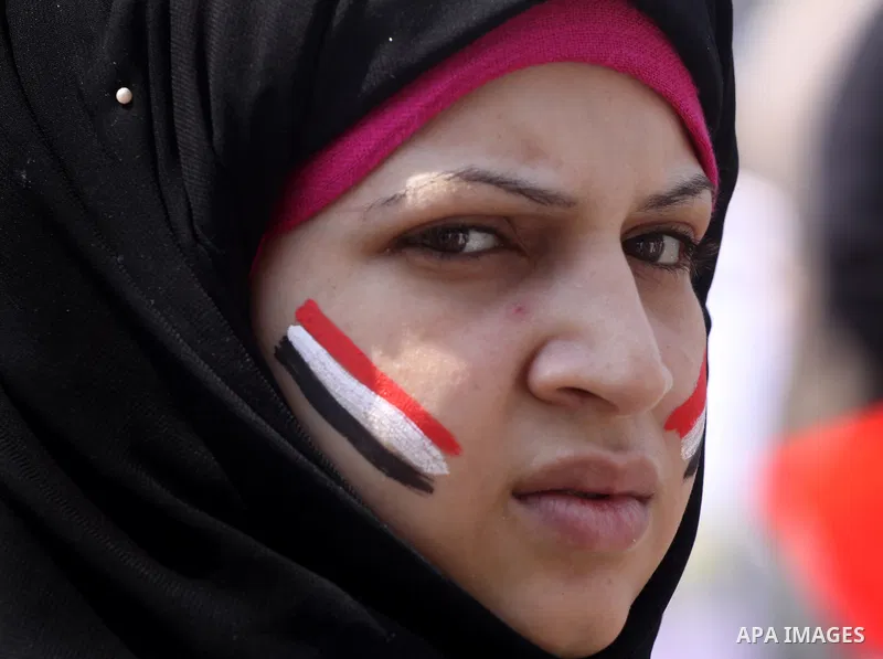 An Egyptian girl paints the Egyptian flag on his face at Tahrir Square while hundreds of Egyptians demonstrate against the expansion of the Emergency Law at Al Tahrir Square. The law allows censorship, government impriso...