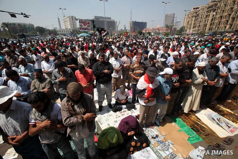 Egyptians during performing their Friday prayers while hundreds of Egyptians demonstrate against the expansion of the Emergency Law at Al Tahrir Square. The law allows censorship, government imprisonment and more during...