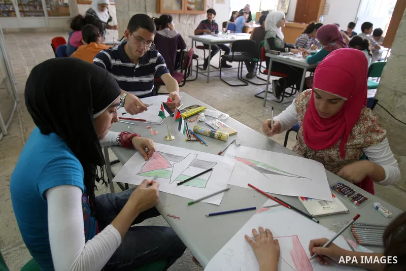 Palestinian students take part in a drawing session as part of a campaign calling for a Palestinian state with full UN membership at a school in the West Bank city of Nablus on September 17, 2011, as the Palestinians are...