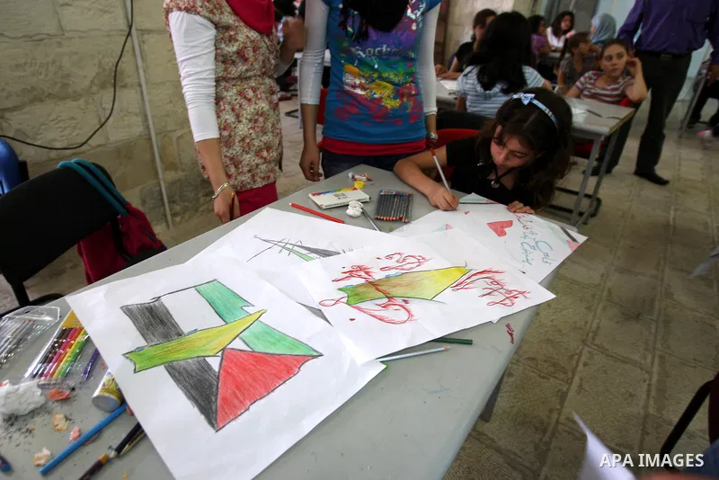Palestinian students take part in a drawing session as part of a campaign calling for a Palestinian state with full UN membership at a school in the West Bank city of Nablus on September 17, 2011, as the Palestinians are...