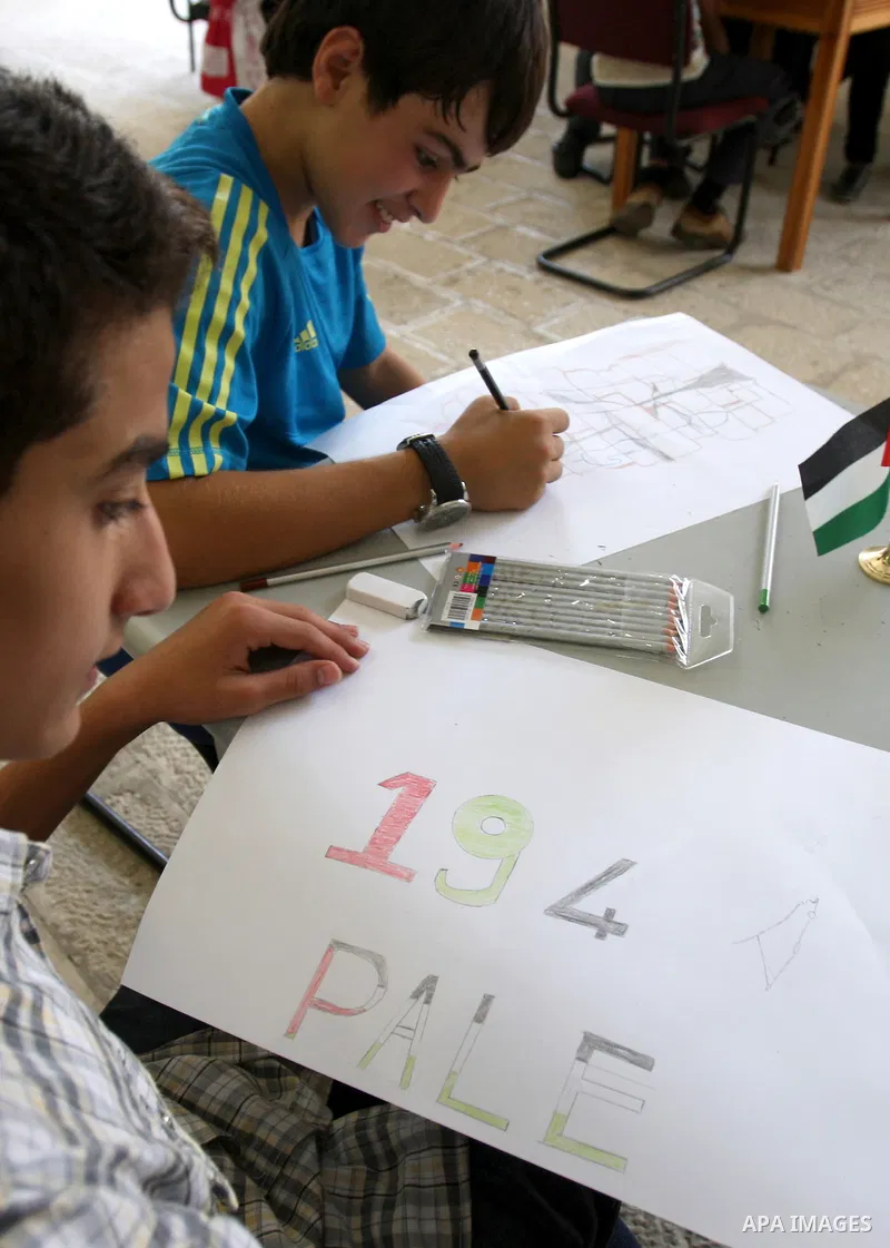 Palestinian students take part in a drawing session as part of a campaign calling for a Palestinian state with full UN membership at a school in the West Bank city of Nablus on September 17, 2011, as the Palestinians are...