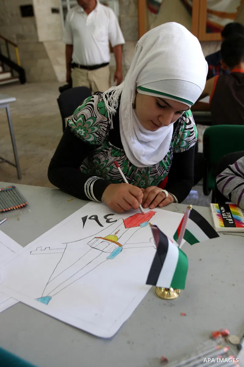 Palestinian students take part in a drawing session as part of a campaign calling for a Palestinian state with full UN membership at a school in the West Bank city of Nablus on September 17, 2011, as the Palestinians are...