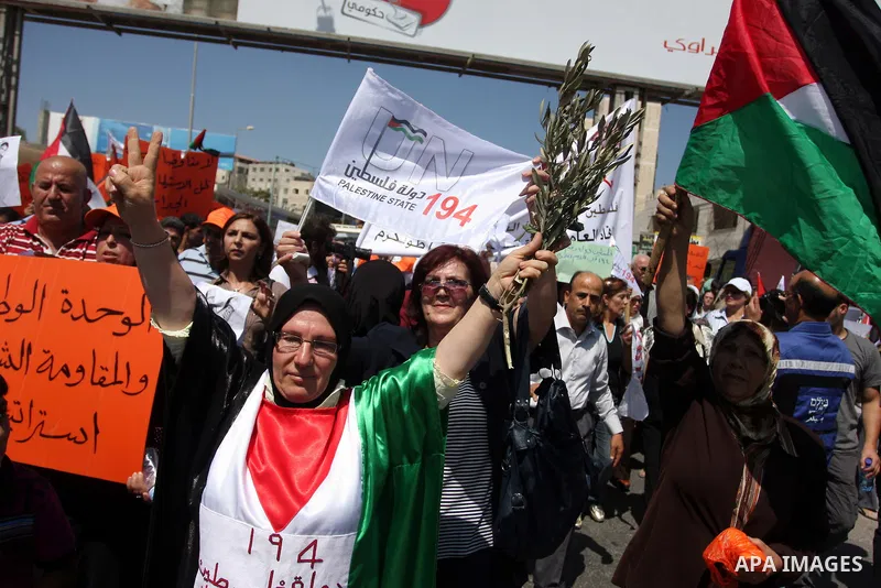 Palestinians wave national flags during a protest calling for a Palestinian state with full UN membership at the Qalandia Israeli checkpoint in the West Bank, near Ramallah, on Sep. 17, 2011. The Palestinians are prepari...