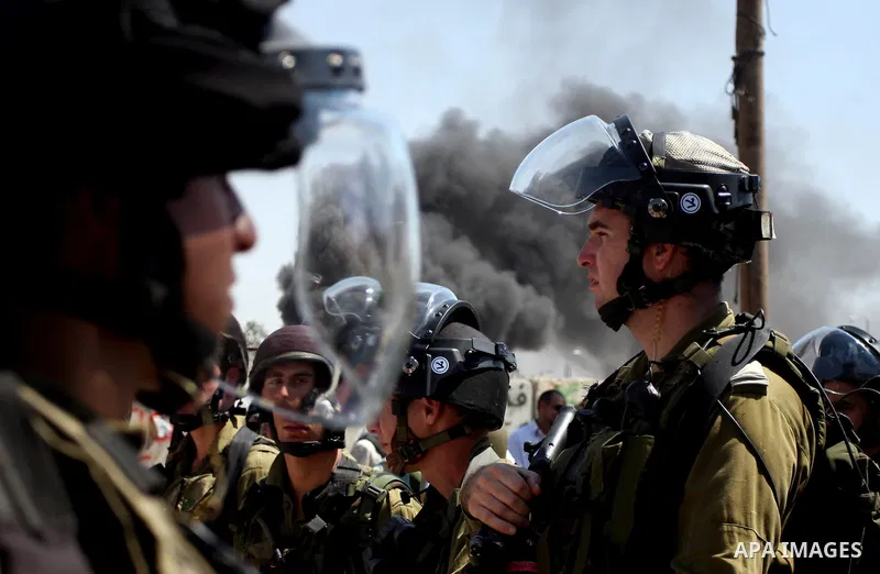 Israeli forces stand at the Qalandia Israeli checkpoint during a protest calling for a Palestinian state with full UN membership, in the West Bank, near Ramallah, on Sep. 17, 2011. The Palestinians are preparing to submi...